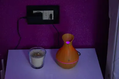 a table with a vase and a glass of milk at Apartmani Tajna in Paraćin