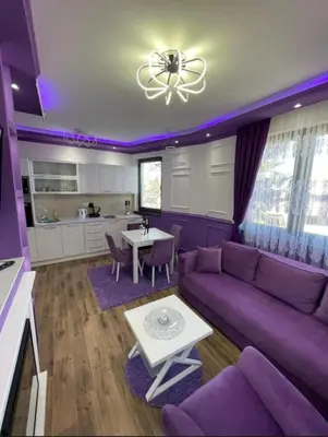 a purple living room with a purple couch and a table at VIOLET QUEEN in Kopaonik