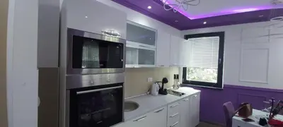 a kitchen with a stove and a sink and purple ceilings at VIOLET QUEEN in Kopaonik
