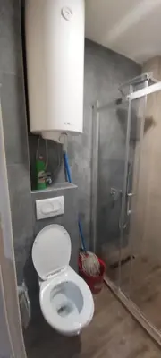 a bathroom with a white toilet and a shower at VIOLET QUEEN in Kopaonik