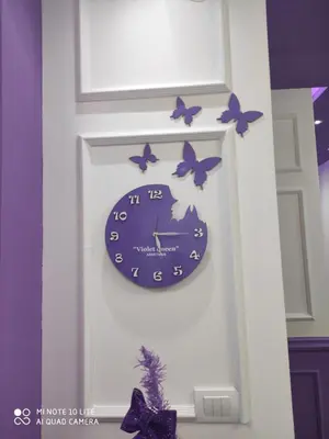 a clock on a wall with butterflies on it at VIOLET QUEEN in Kopaonik