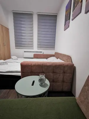 a living room with a couch and a table at Sunčani Breg-Sunčana KOP studio in Kopaonik