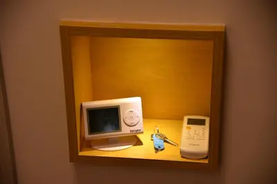 a cabinet with a computer and a phone on a shelf at Bella apartments in Kruševac