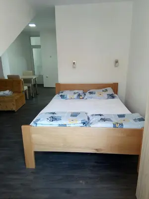 a bedroom with a bed with a wooden frame at Apartmani Marković in Soko Banja