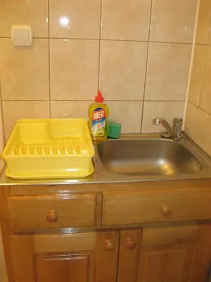 a sink with a yellow tray on top of it at Apartmani Marković in Soko Banja