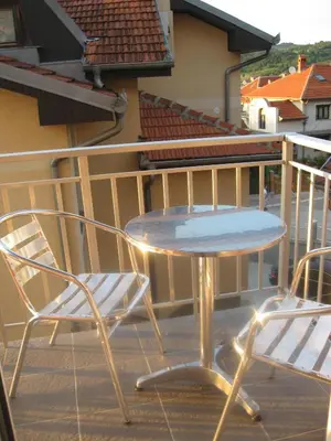 a table and two chairs on a balcony at Apartmani Marković in Soko Banja