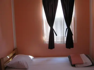 a bedroom with a bed and a window at Apartmani Marković in Soko Banja