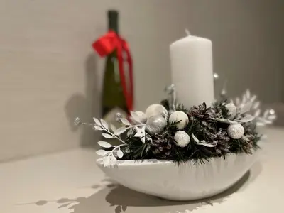 a white bowl with a candle and christmas decorations at Star Hill - Koznik Konaci in Kopaonik