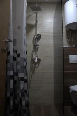 a bathroom with a shower with a glass door at Kraljev Konak in Kopaonik