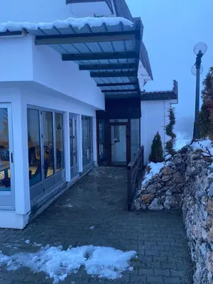 a building with a porch with snow on the ground at Kraljev Konak in Kopaonik