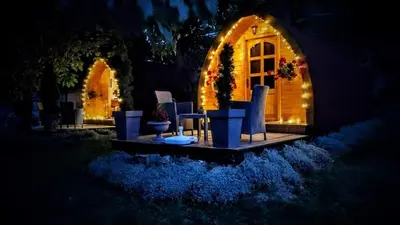 a house with an arched door with lights on it at Vila Jelena - BUNGALOV in Crni Vrh
