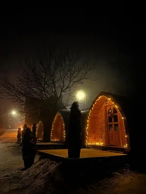 a wooden igloo with lights on it at night at Vila Jelena - BUNGALOV in Crni Vrh