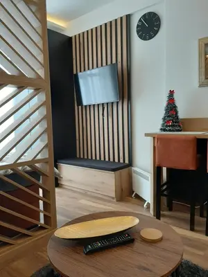 a living room with a piano and a table at PRESIDENT KOP A-1 in Kopaonik