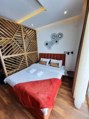 a bedroom with a large bed with a wooden headboard at PRESIDENT KOP A-1 in Kopaonik