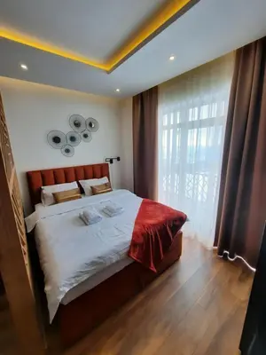 a bedroom with a bed and a large window at PRESIDENT KOP A-1 in Kopaonik