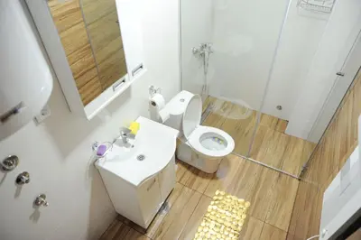 a bathroom with a toilet and a sink and a shower at Apartman Kalina Suncani Breg in Kopaonik