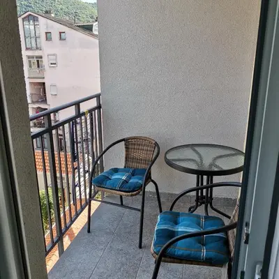 a balcony with two chairs and a table at Apartman Lea & parking u garaži in Soko Banja