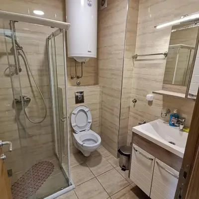 a bathroom with a toilet and a shower and a sink at Apartman Lea & parking u garaži in Soko Banja