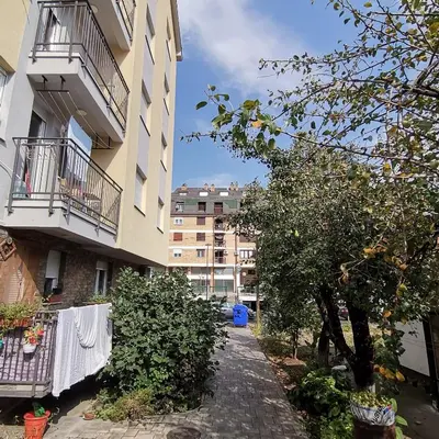 an apartment building with a towel hanging on a clothes line at Apartman Lea & parking u garaži in Soko Banja