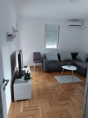 a living room with a couch and a table at Vrnjačka Banja Apartman in Vrnjačka Banja