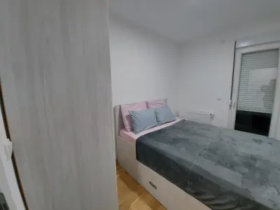 a bedroom with a bed with two pillows on it at Vrnjačka Banja Apartman in Vrnjačka Banja
