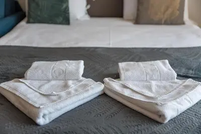 two towels are sitting on top of a bed at Apartman Klara S 23 in Kopaonik
