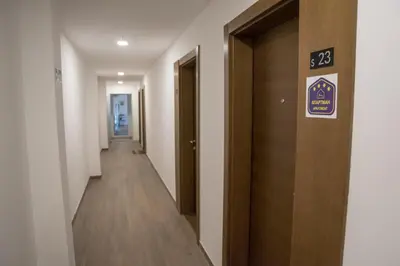 a hallway with a door with a sign on it at Apartman Klara S 23 in Kopaonik