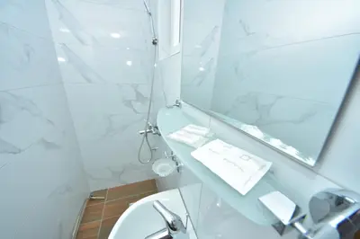 a bathroom with a sink and a mirror at Lužnjanin restoran i sobe in Jošanička Banja