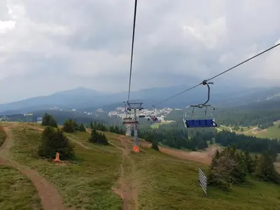 a gondola ride on a hill with a road at Apartman K5 Milmari Resort in Kopaonik