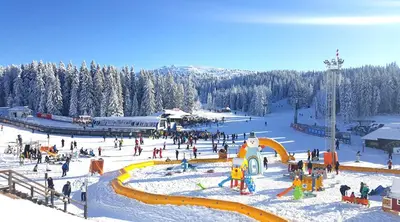 a group of people on a ski slope in the snow at Apartman K5 Milmari Resort in Kopaonik