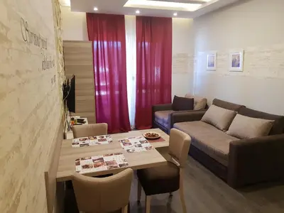 a living room with a table and a couch at Apartman K5 Milmari Resort in Kopaonik