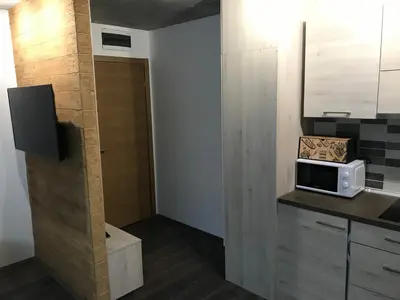 a small kitchen with a microwave on a counter at Suncani breg treska in Kopaonik