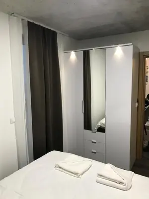 a bedroom with a white bed and a mirror at Suncani breg treska in Kopaonik