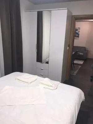 a bedroom with a white bed and a mirror at Suncani breg treska in Kopaonik
