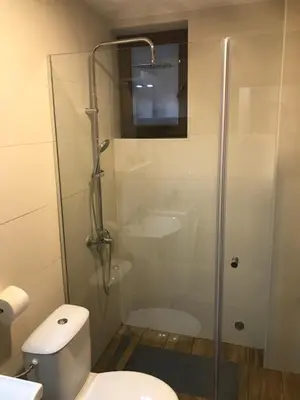 a bathroom with a shower with a toilet and a sink at Suncani breg treska in Kopaonik