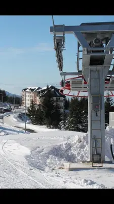 a ski lift with snow on the ground at Suncani breg treska in Kopaonik