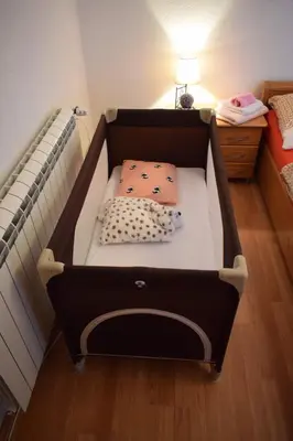 a small bed in a room with a bed sqor at Vila Jakovljević in Jošanička Banja