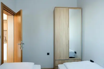 a bedroom with two beds and a mirror at Vila Planinsko Blago in Kopaonik