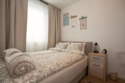a small bedroom with a bed and a window at Dream View Apartment in Kopaonik
