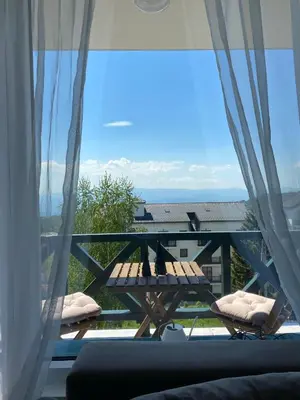 a balcony with a picnic table and a view of the ocean at Dream View Apartment in Kopaonik