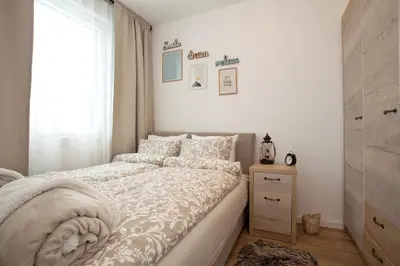a small bedroom with a bed and a window at Dream View Apartment in Kopaonik