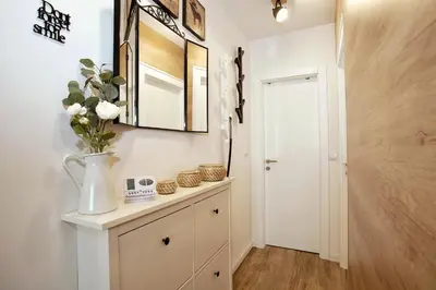 a bathroom with a vase of flowers on a cabinet at Dream View Apartment in Kopaonik