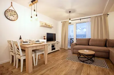 a living room with a table and a couch at Dream View Apartment in Kopaonik