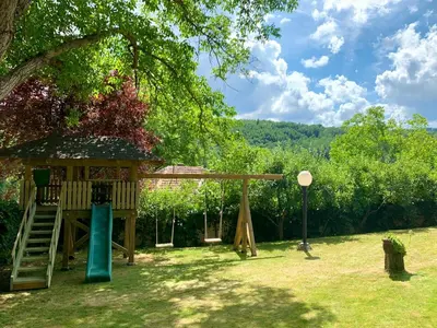 a playground in a yard with a tree at Vila Djordjevic - Priroda vas okruzuje in Brus