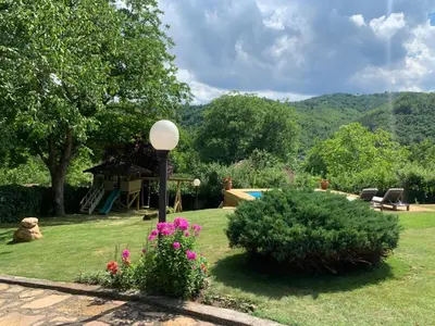 a garden with a bench and a playground at Vila Djordjevic - Priroda vas okruzuje in Brus