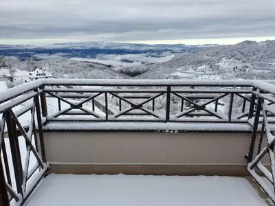 a balcony covered in snow with a view at Milmari P79 in Kopaonik