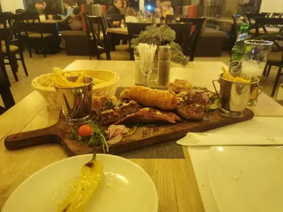 a plate of food on a wooden table at Milmari P79 in Kopaonik