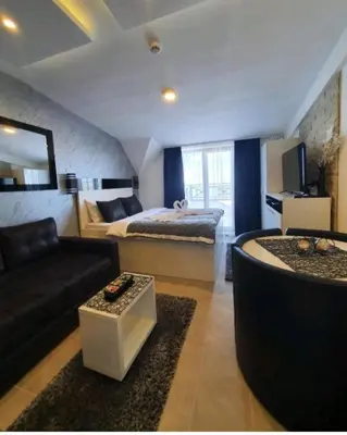 a large living room with a bed and a couch at Milmari P79 in Kopaonik
