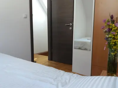 a bedroom with a bed and a vase of flowers at Ema A2 Kraljevi Čardaci in Kopaonik