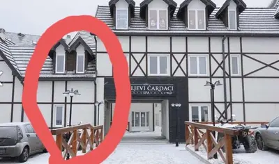 a red sign in front of a building at Ema A2 Kraljevi Čardaci in Kopaonik